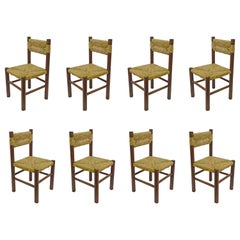 Used Italian 1960s dining chairs in straw and wood in the style of Charlotte Perriand