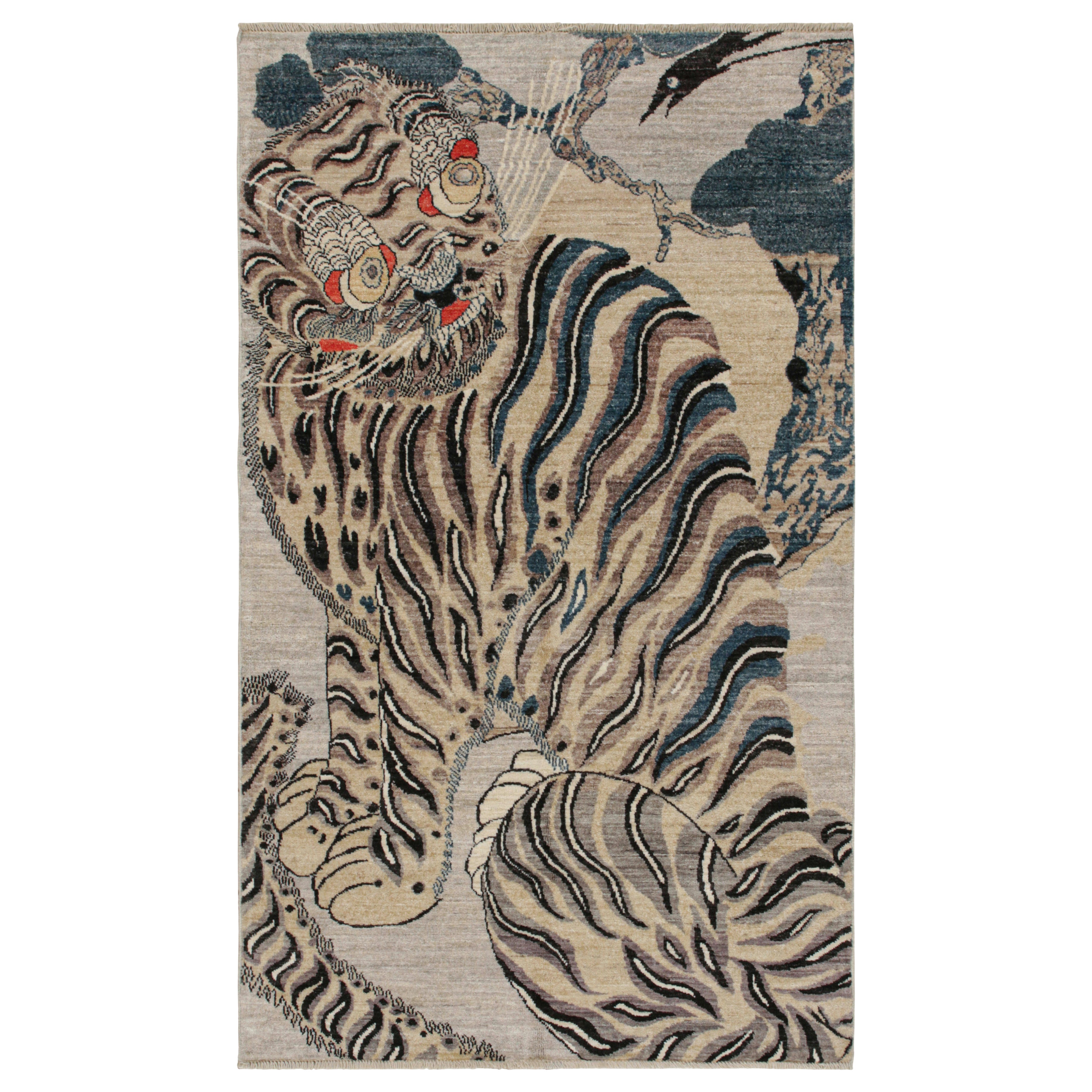 Rug & Kilim's Custom Tiger-Skin Rug with Beige/Brown, Blue, Black Pictorial (tapis en peau de tigre sur mesure avec pictogramme beige/brun, bleu et noir)