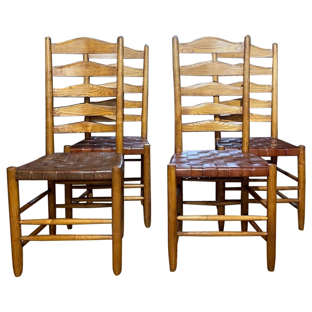 Set of four oak and leather ladder back dining chairs by Gordon Russell For Sale