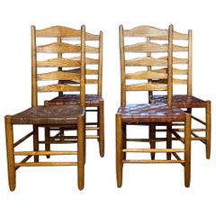 Antique Set of four oak and leather ladder back dining chairs by Gordon Russell