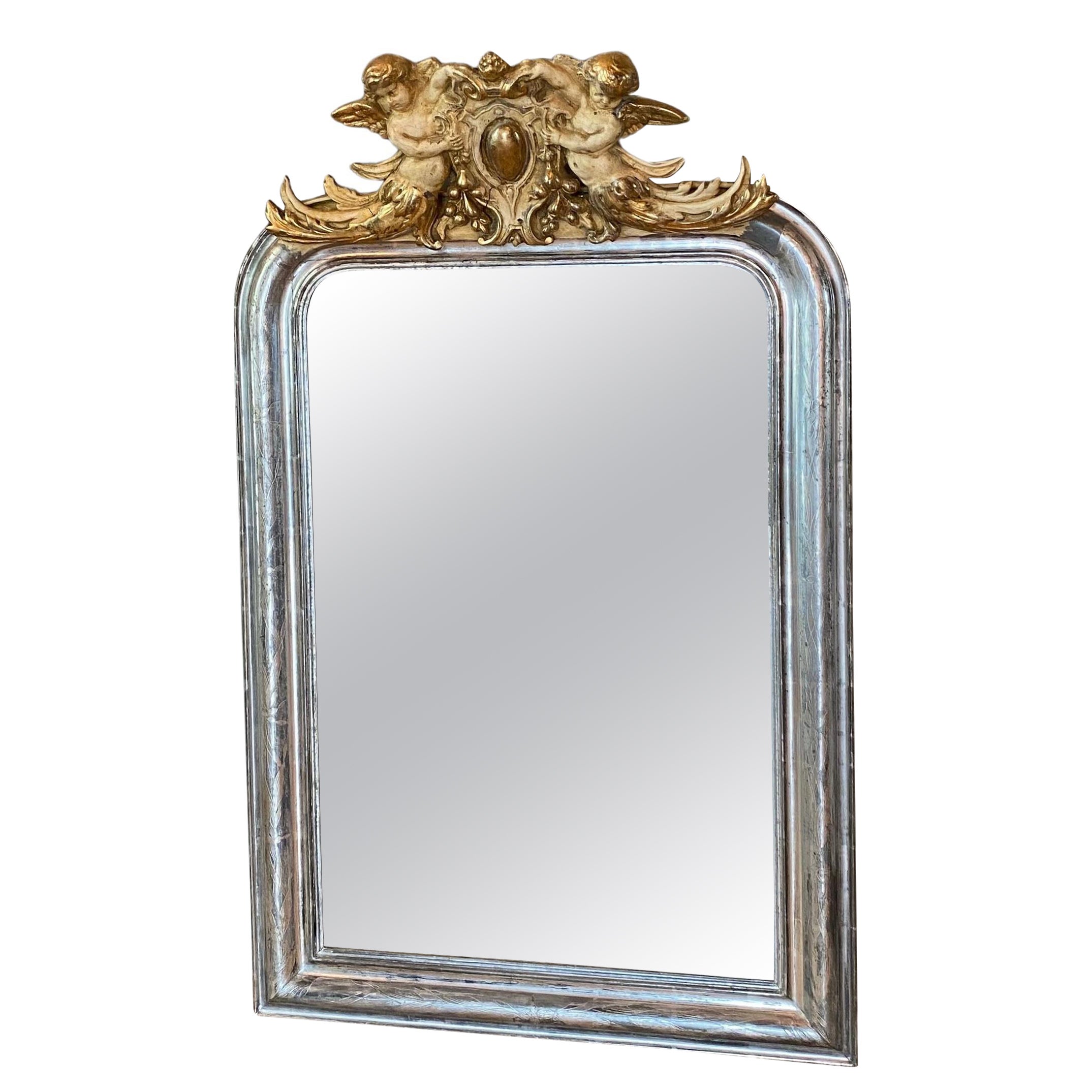 19th century silver leaf gilt French mirror with a crest with putti