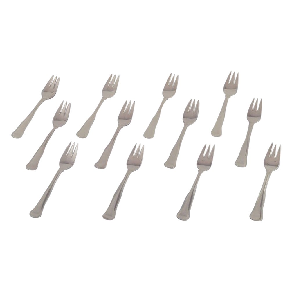 Cohr, Danish silversmith. Set of twelve "Old Danish" cake forks in 830 silver.