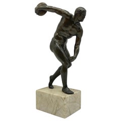 Antique bronze athlete as discus thrower
