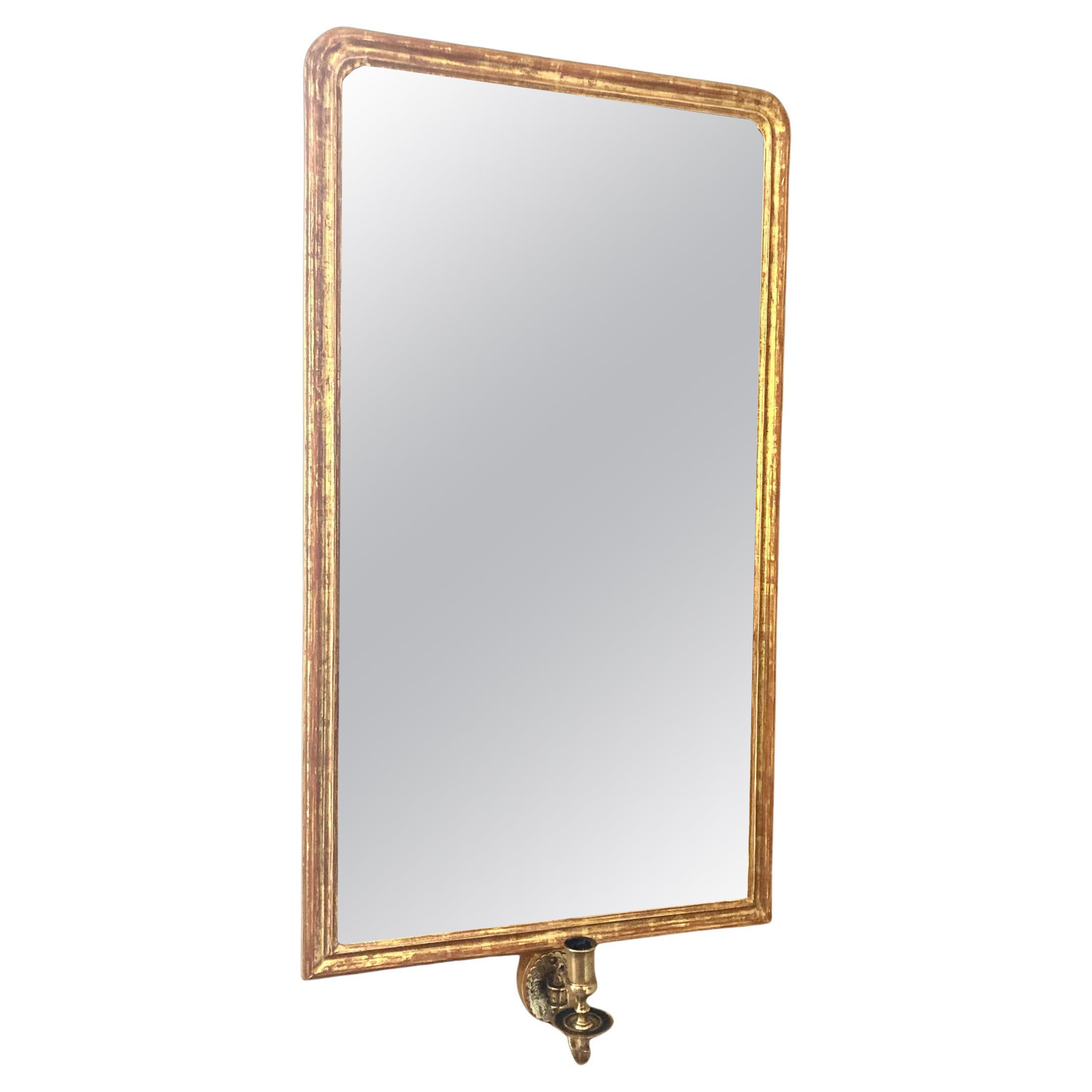 Giltwood wall mirror with single brass candle arm For Sale