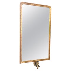 Giltwood wall mirror with single brass candle arm
