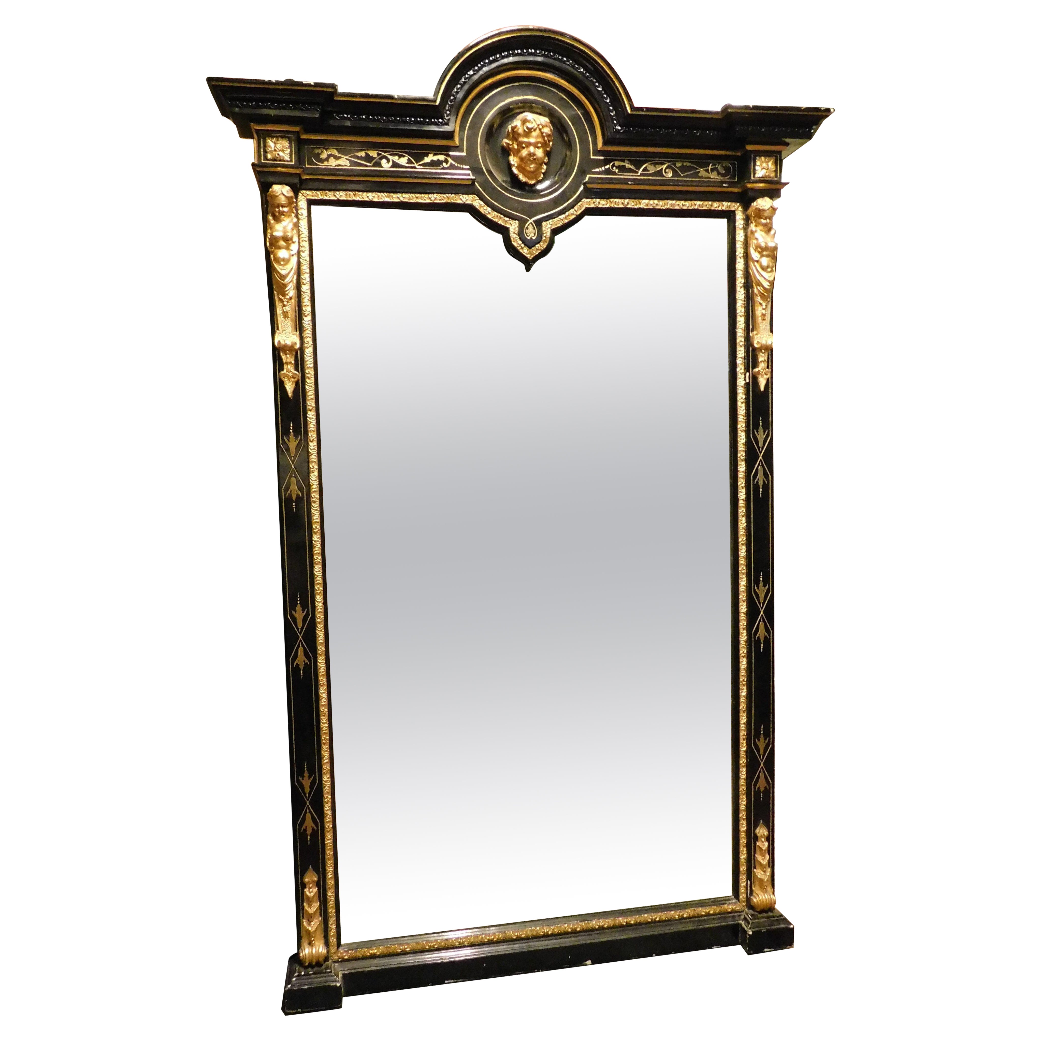 Mirror in black lacquered wood, with rich golden sculptures, Italy For Sale