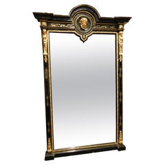 Mirror in black lacquered wood, with rich golden sculptures, Italy