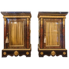 Antique A fine pair of French Boulle and gilt bronze mounted cabinets. Black marble tops