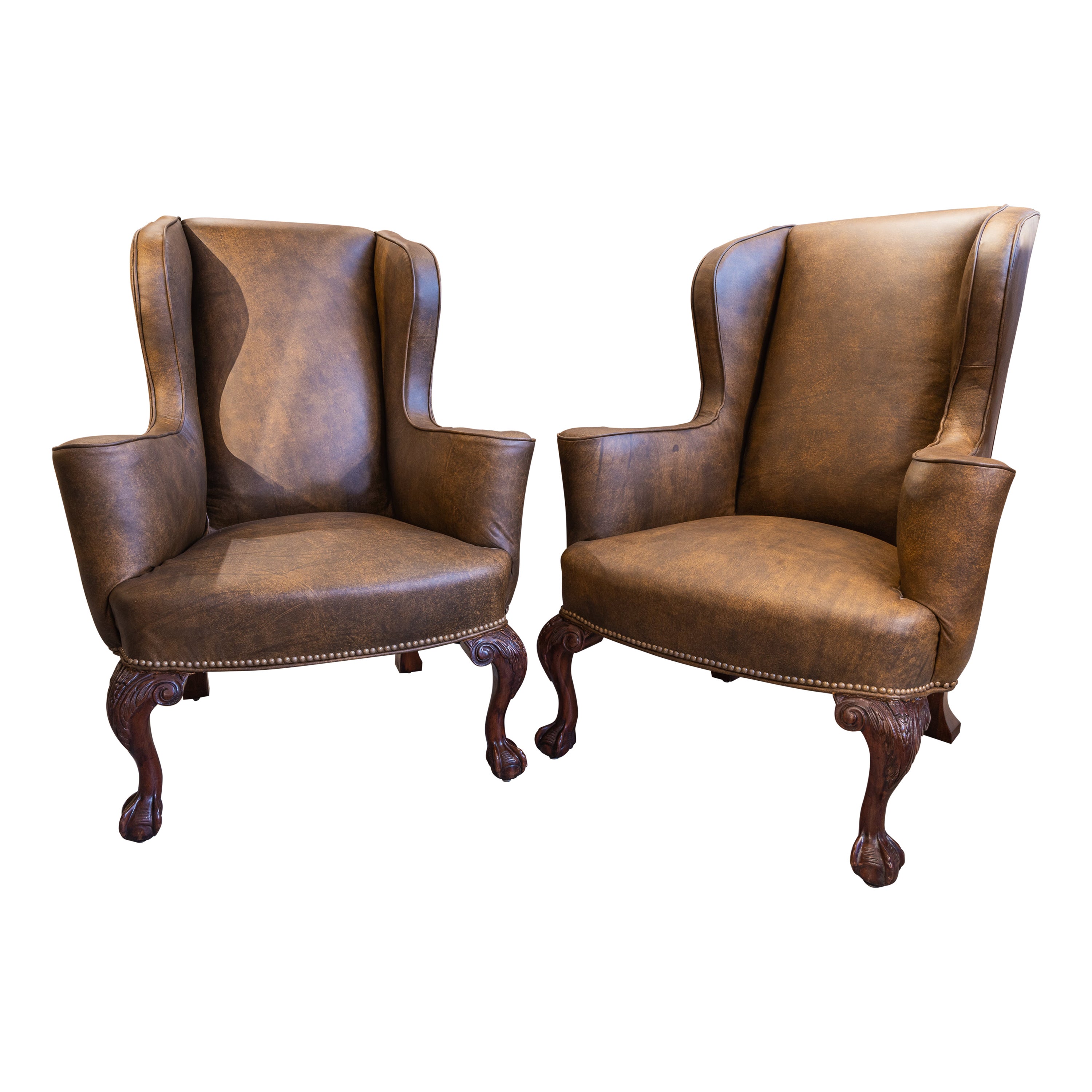 A  pair of 19th c George 1 style mahogany English wingchairs . Ball and claw 