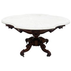 A 19th Century mahogany table with a cartouche-shaped marble top, ca 1840