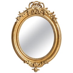 Petit miroir ovale français ancien du 19ème siècle, doré à l'or avec crête