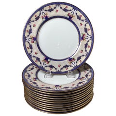 Antique A set of twelve dinner plates by Royal Doulton, a renowned English ceramic mfg.