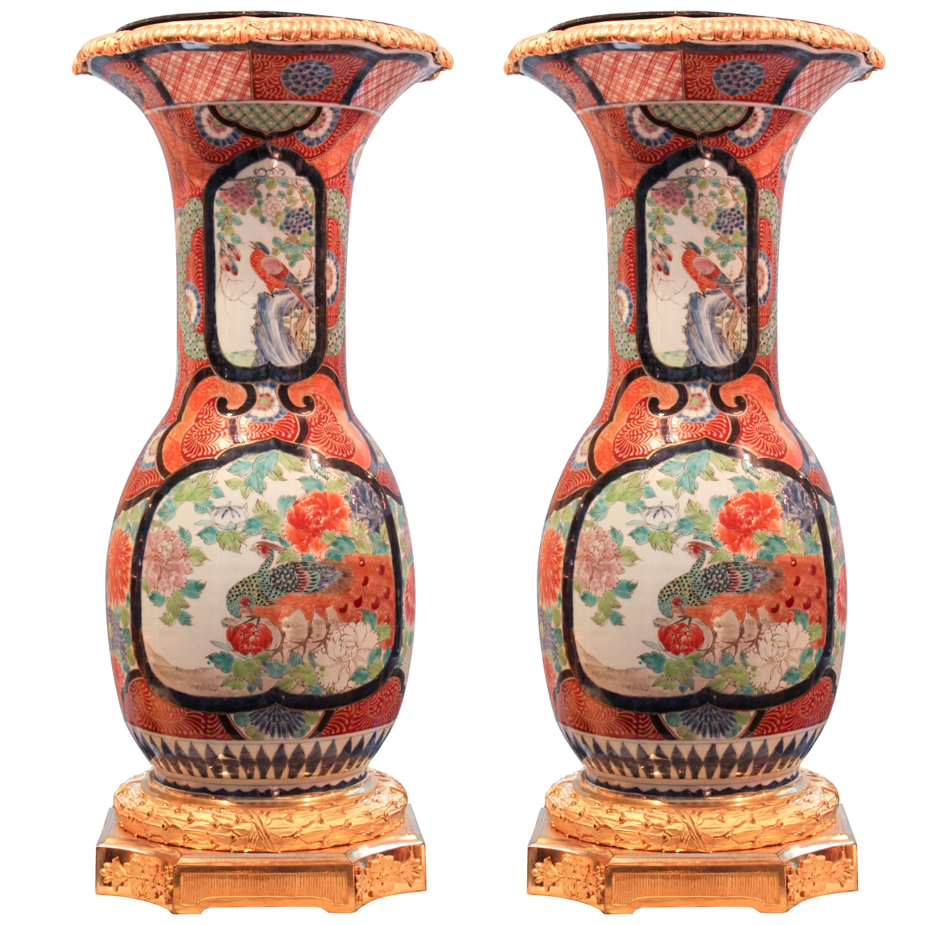 Pair of Japanese Kutani Urns on Gilt Bronze Pedestals For Sale