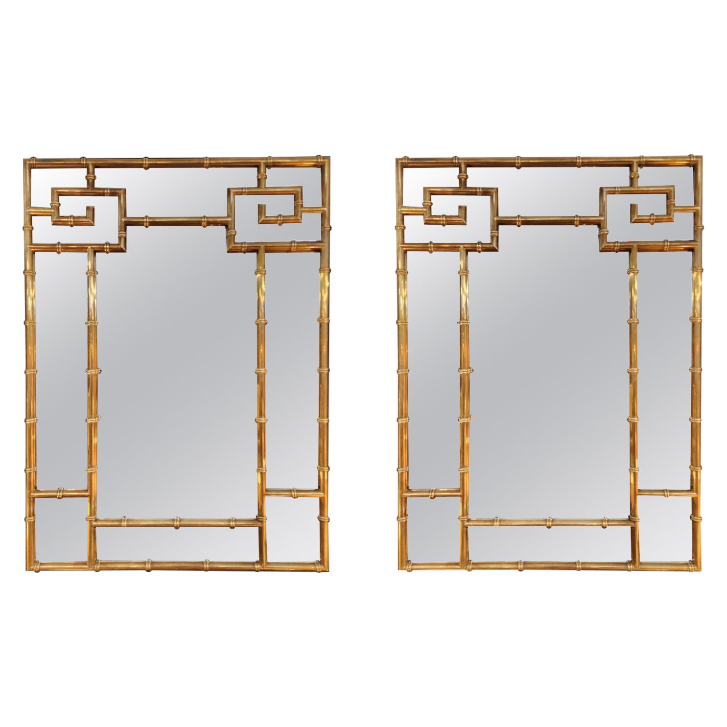 A rare to find, matched pair of brass mirrors by mastercraft. Designed by William Doezema for Mastercraft, and produced in the 1970's.  This pair is in excellent condition and has a gorgeous patina. These are not lacquered and can be polished to a