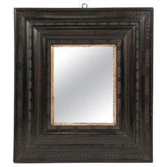 Miroir italien en bois ébonisé et doré