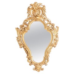 Used Regency style mirror in carved and gilded wood. 1950s.