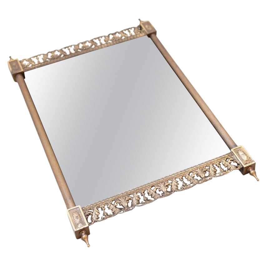 Wall mirror, brass with carved and pierced profiles at the top and For Sale