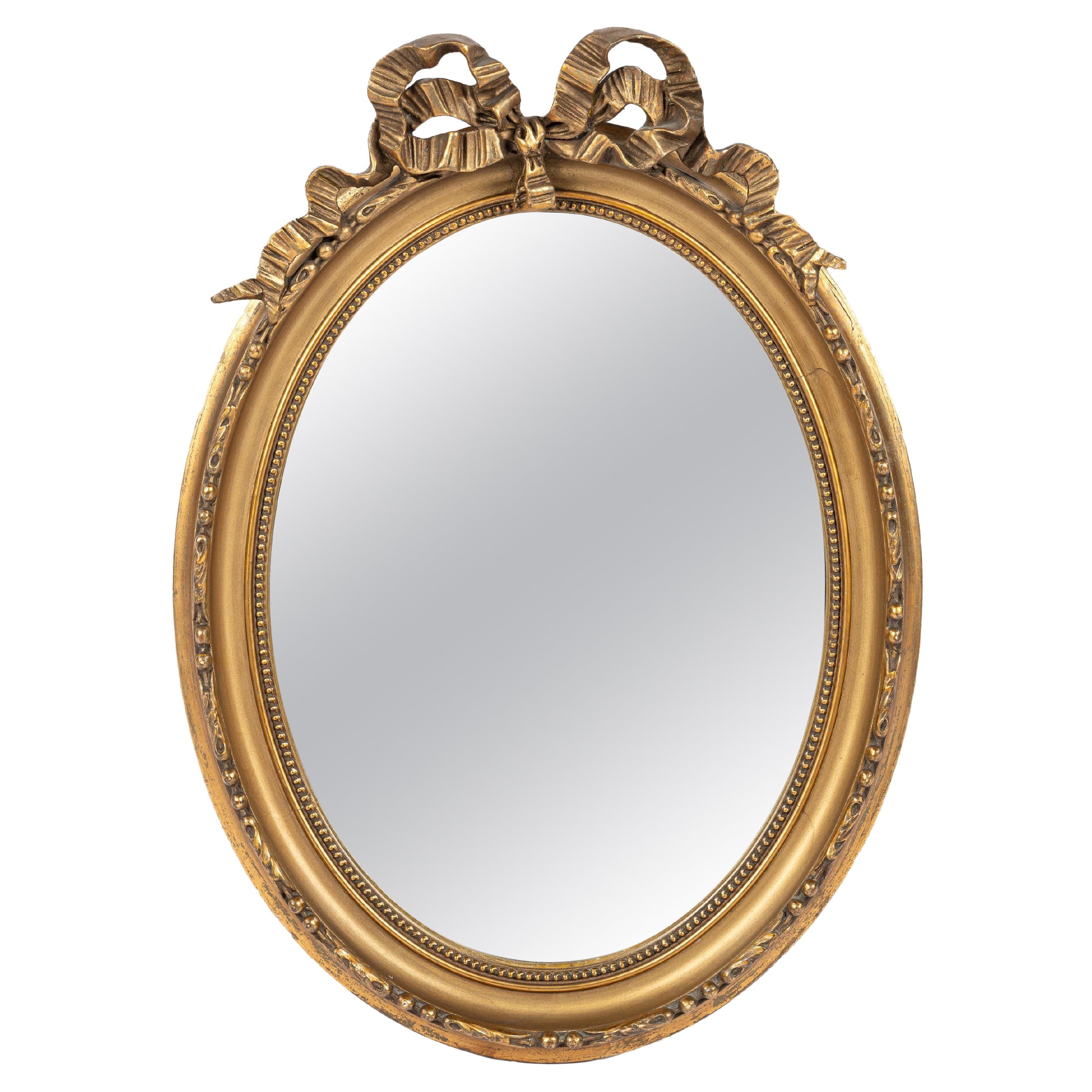 Antique début du 20e siècle, miroir à ruban ovale à nœuds en or doré français.