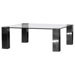 Coffee table in chromed metal and dark glass.