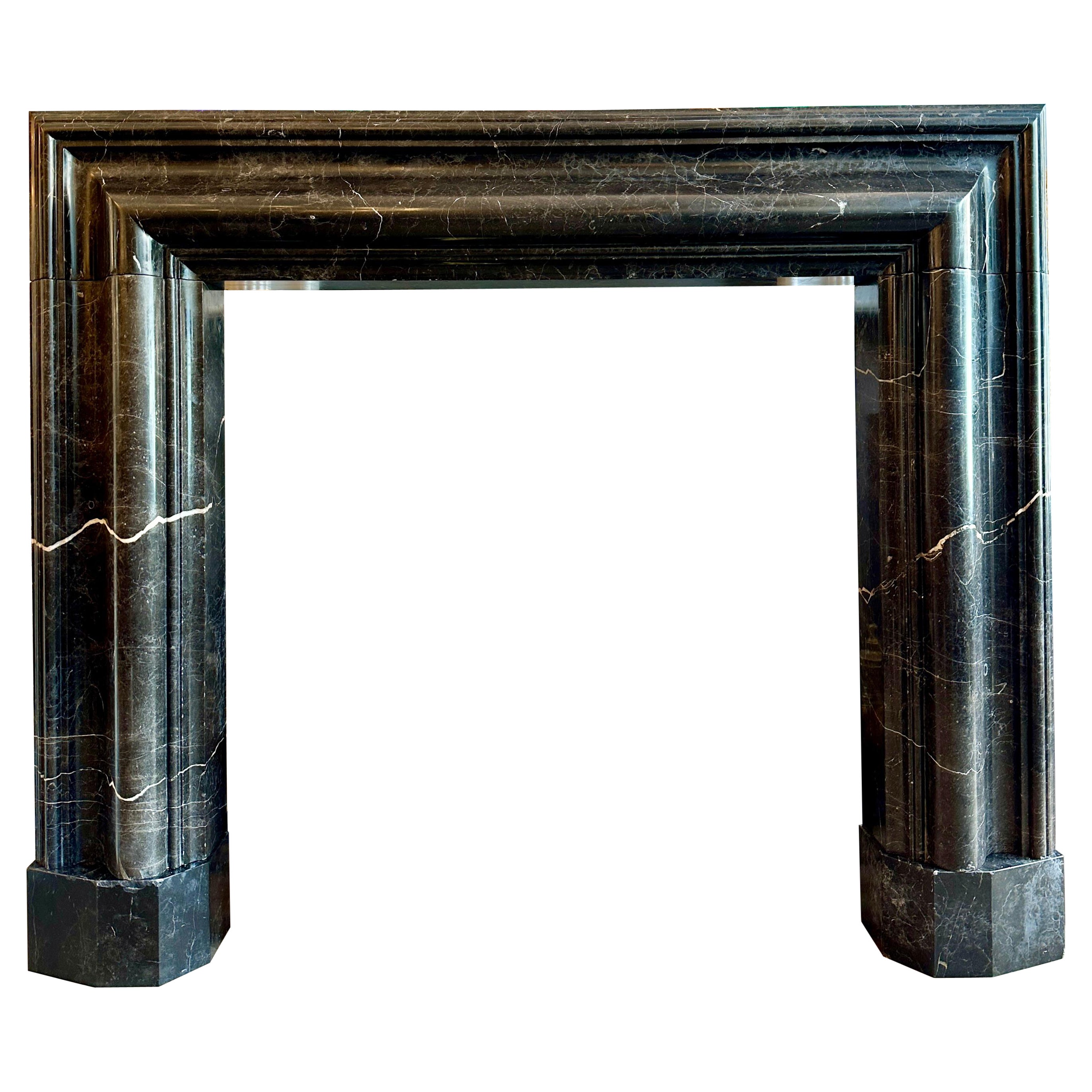 A Large Reclaimed Black Marble Bolection Fireplace Mantel For Sale