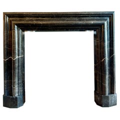 A Large Reclaimed Black Marble Bolection Fireplace Mantel