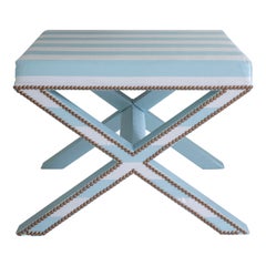 The upholstered Alexander X-Frame stool in striped silk with nailing detail