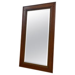 Retro Style Wall Mirror With Ornate Golden Toned Banding Around the Frame.