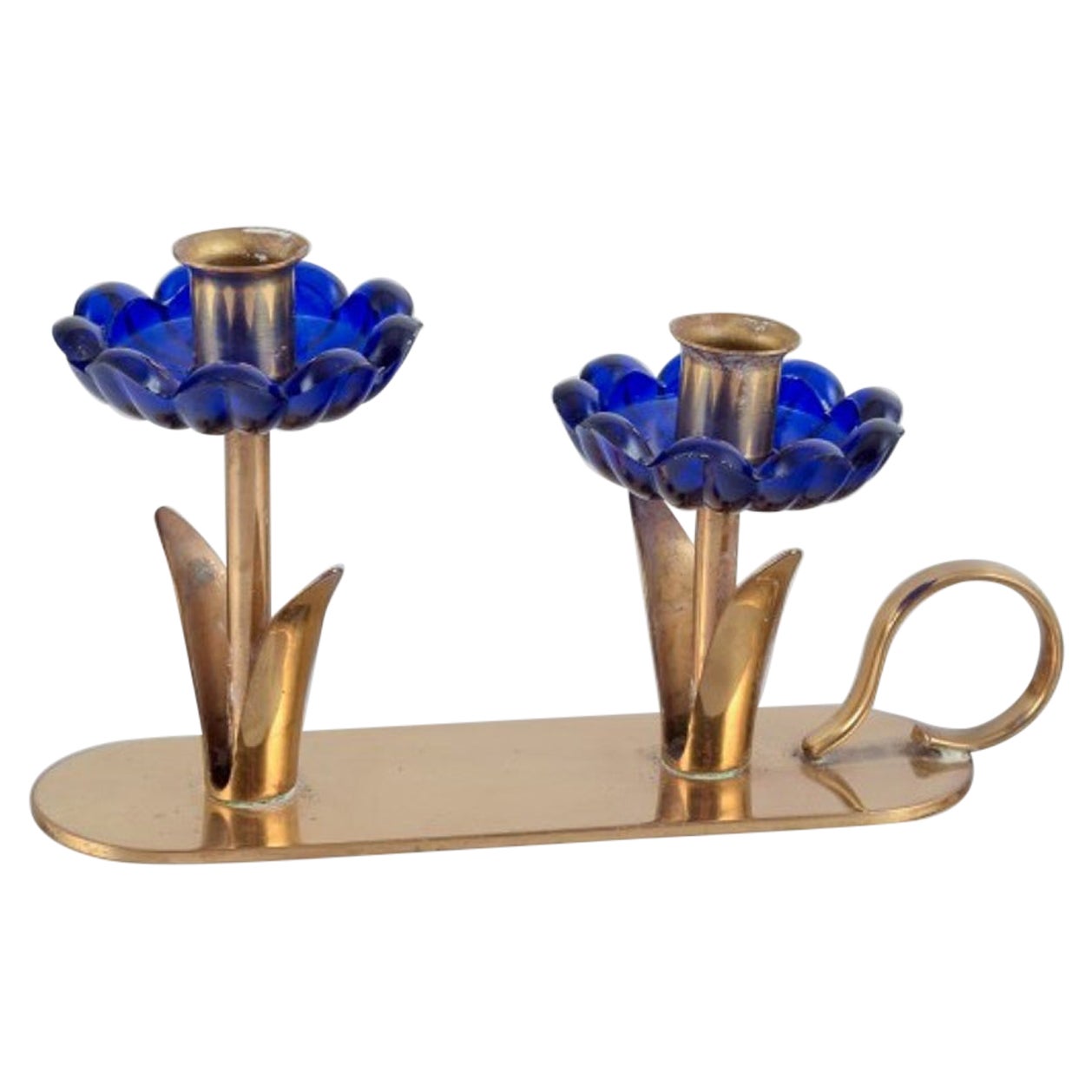 Gunnar Ander for Ystad Metall.  Candlestick holder in brass and blue art glass For Sale