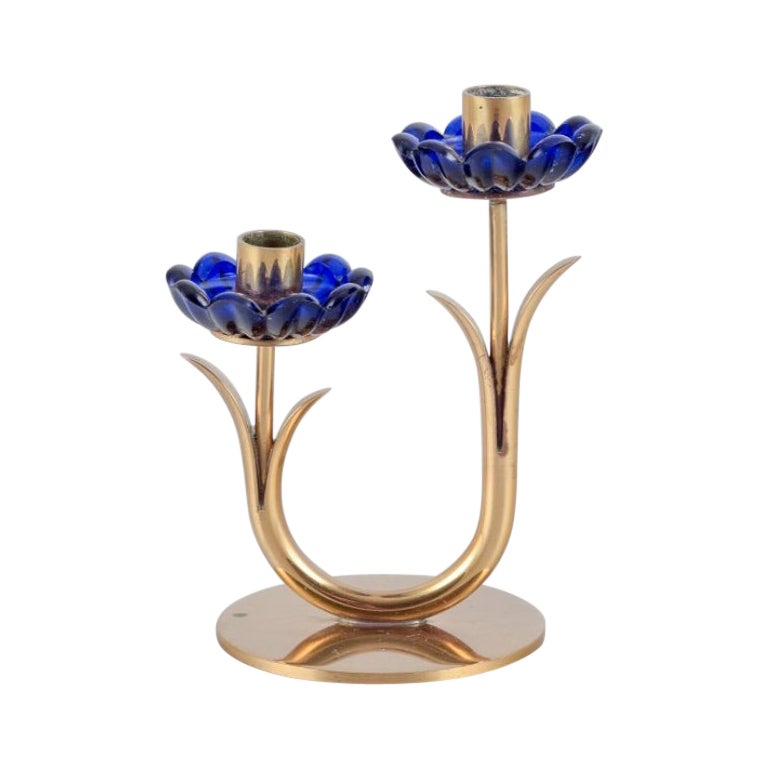 Gunnar Ander for Ystad Metall/ Candlestick holder in brass and blue art glass. For Sale