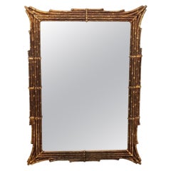 Grand miroir en faux bambou doré