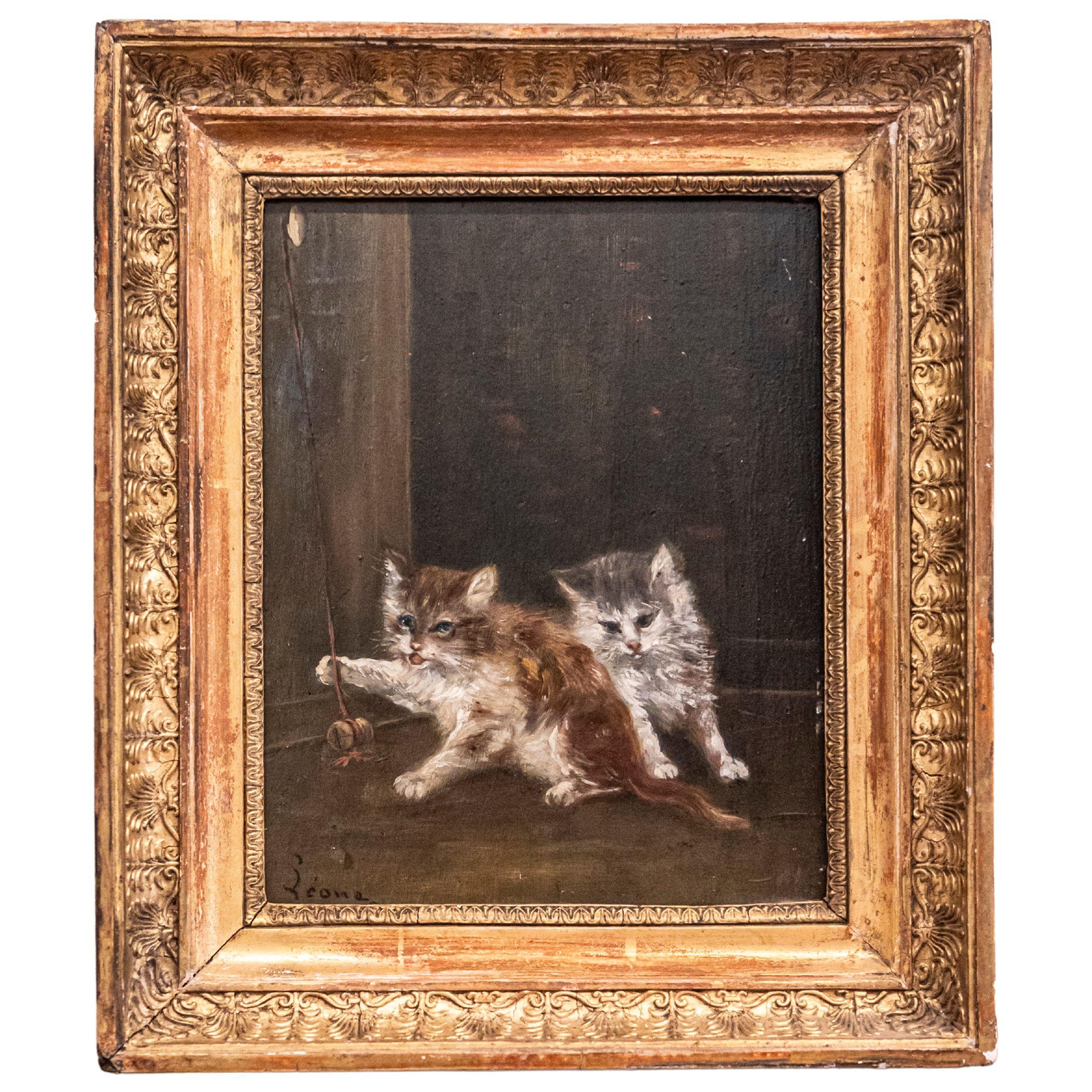 Peinture sur toile française des années 1890 représentant des chatons jouant dans un cadre en bois doré