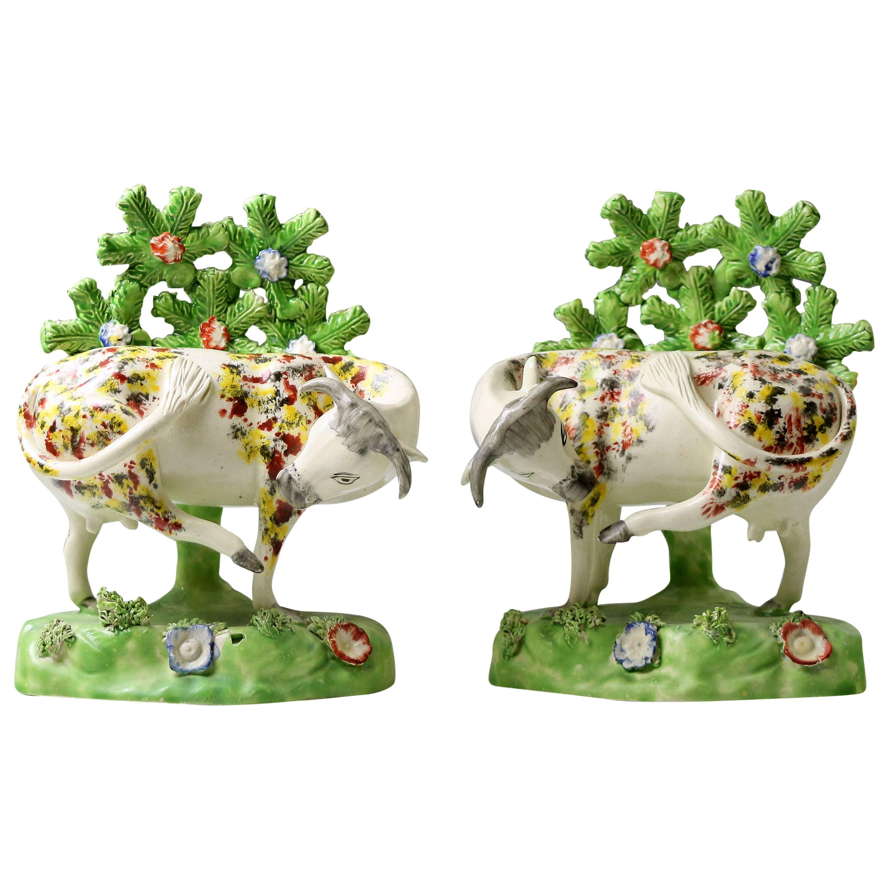 Staffordshire Pottery Figures of Cows on Bases with Bocage Pearlware Glaze For Sale