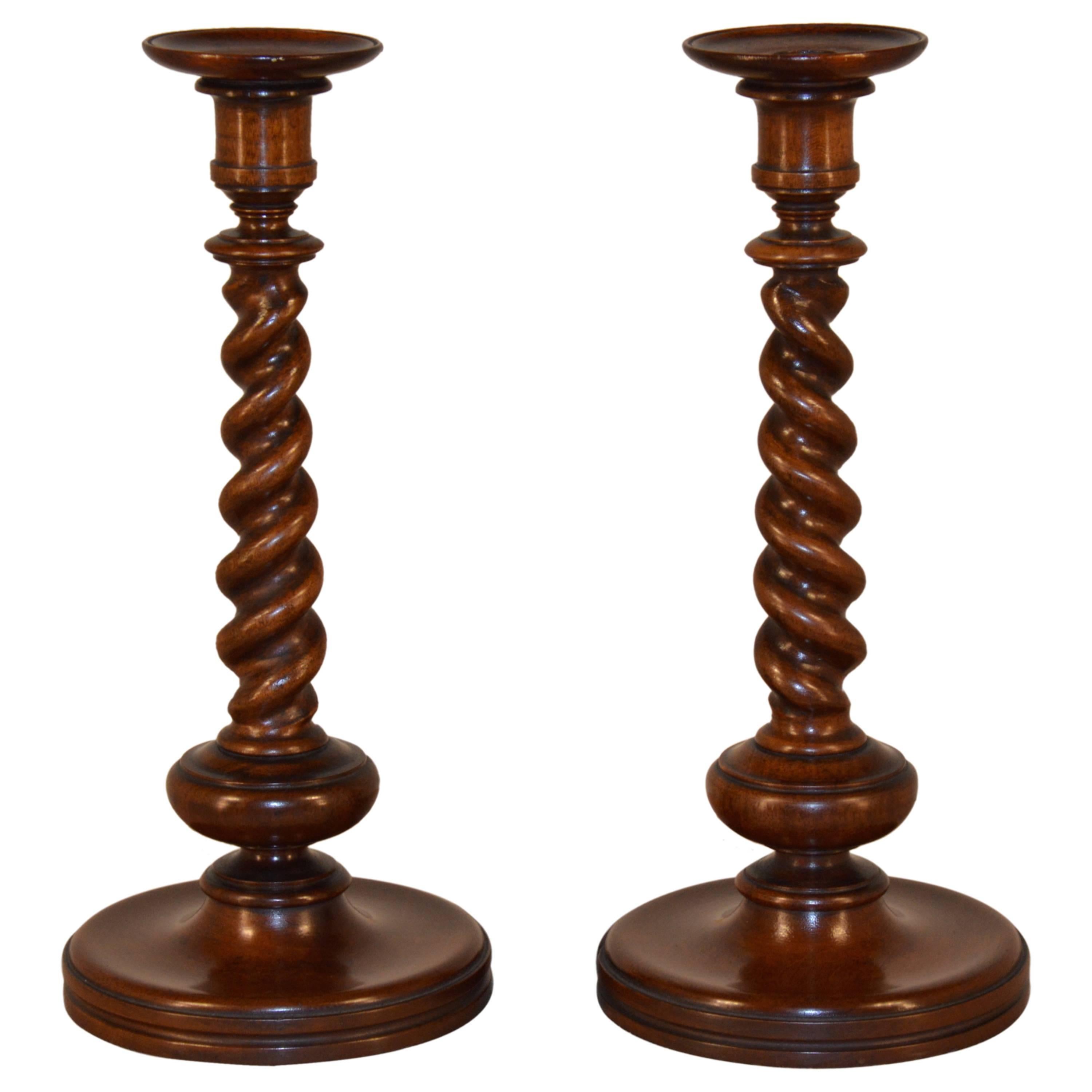 19th century pair of English candlesticks with hand-turned candle cups and barley twist columns, supported on turned bases.