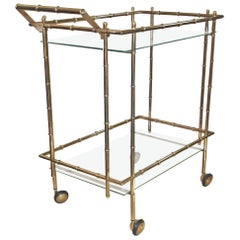 SOLD-Mid Century Modern two tier brass bamboo motif bar cart with Smokey  glass shelves. 29” wide x 16.5” deep x 37” tall. [$125]…
