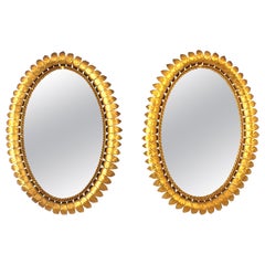 Paire de miroirs ovales en métal doré, années 1950