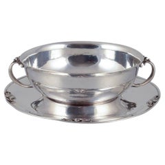 Harald Nielsen for Georg Jensen. Sterling silver bowl with handles on a saucer.