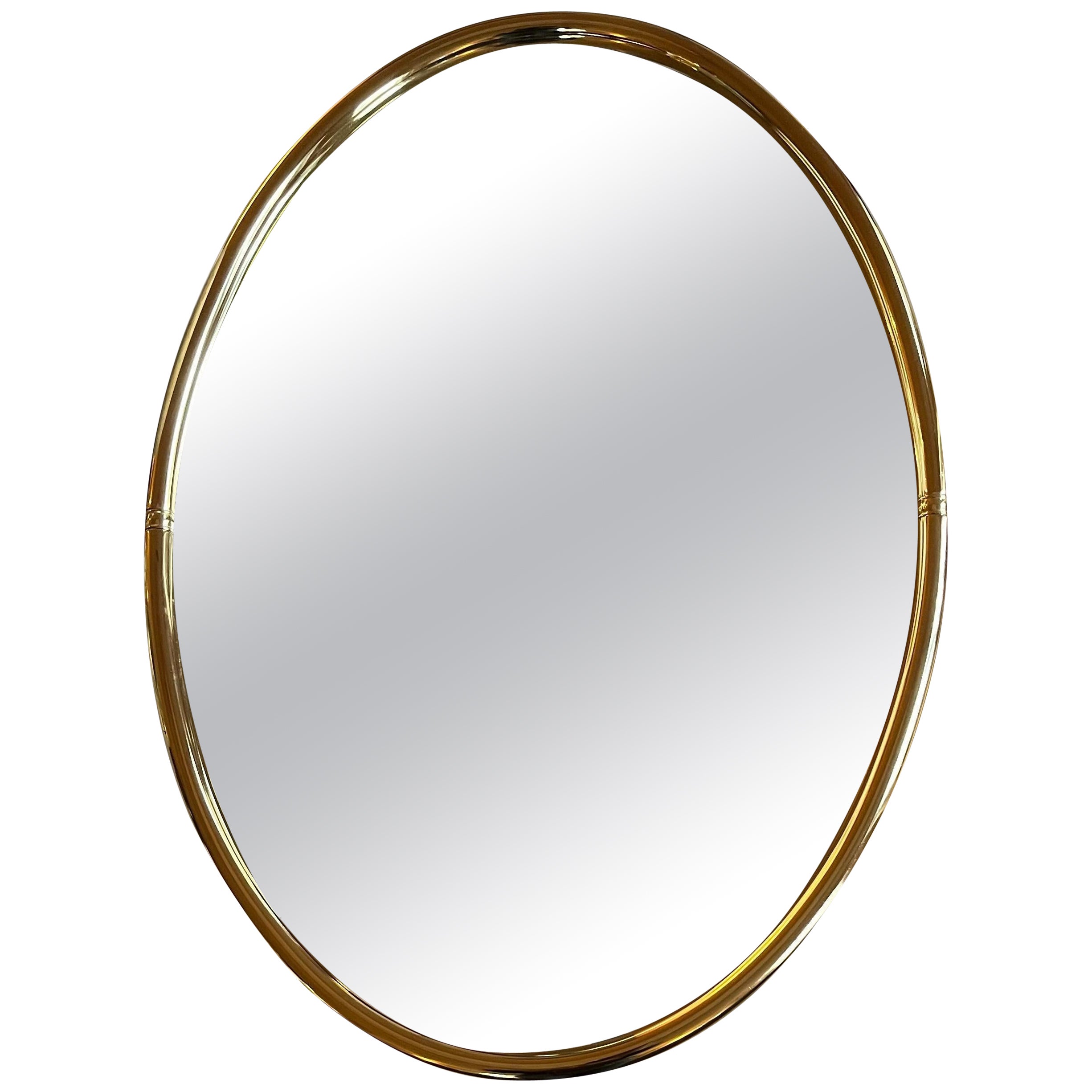 Small oval gilt metal mirror For Sale