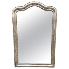 Miroir Louis Philippe ancien en argent doré avec dessus incurvé