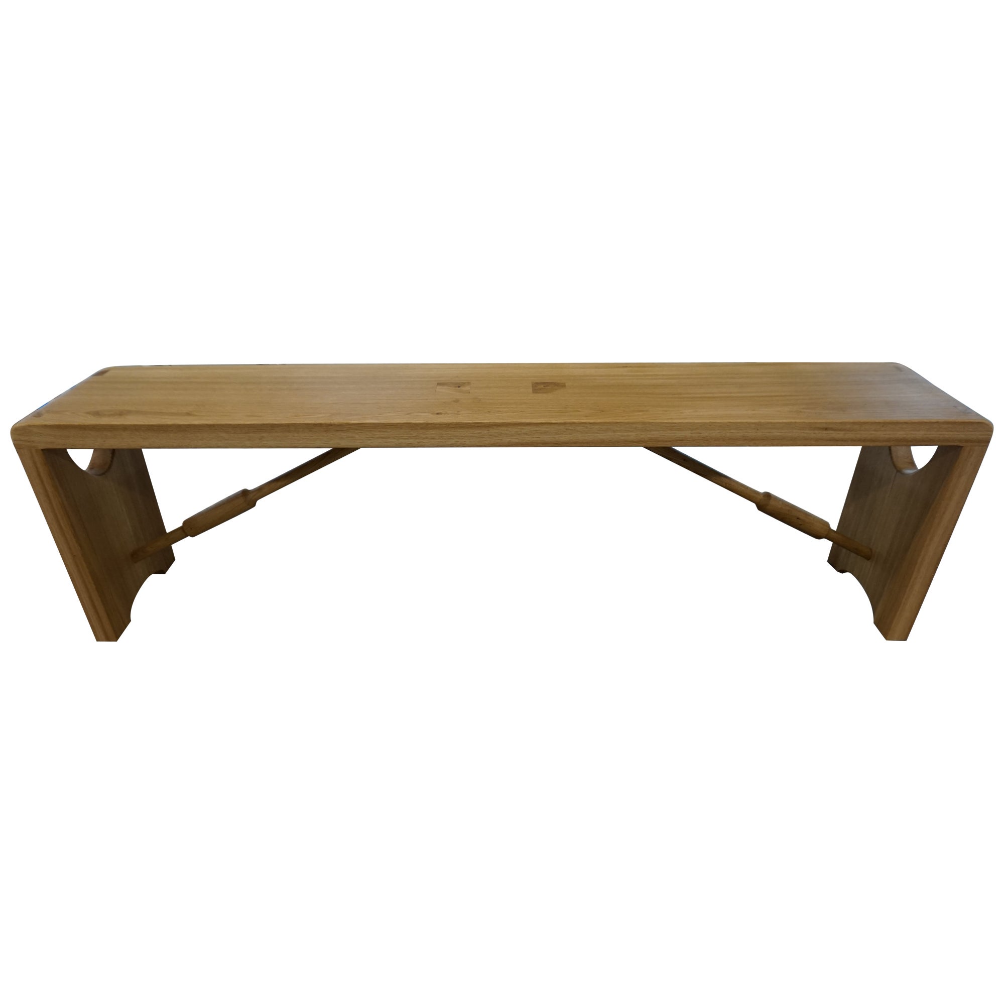 A hand made oak bench perfect for an entryway or to accompany a dining table. Curved corners reveal hand cut dovetail joints for joining the legs to the seat and two elegant spindles stabilise the structure. We wanted to highlight the natural aspect