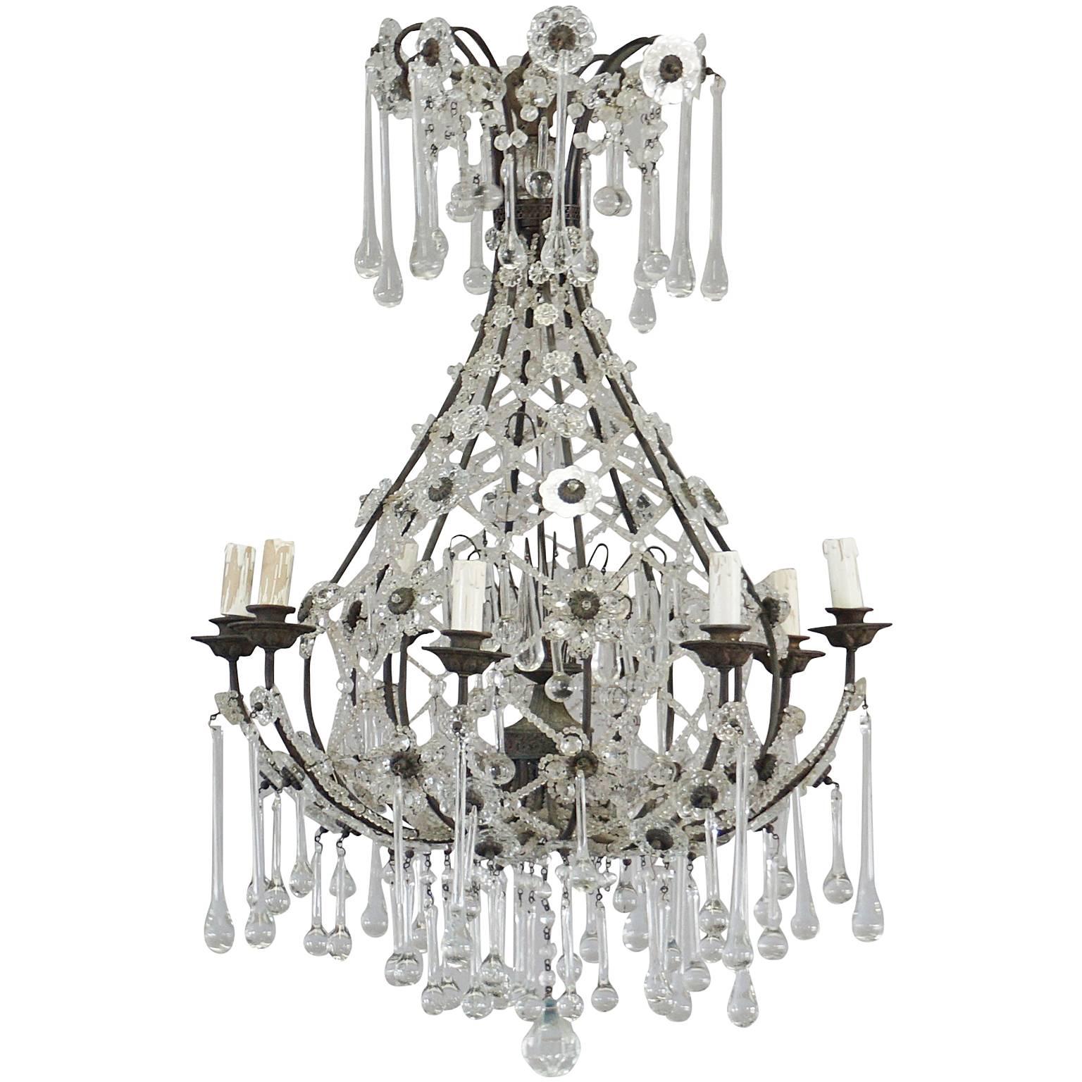 A French vintage Art Deco crystal glass chandelier with basket style and teardrop prism lights. The frame of the ceiling light is made of handcrafted metal, in good condition, featuring a seven light socket. The wires have been renewed. Wear