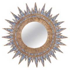A blue textured glass and resin star form mirror in the manner of Line Vautrin.