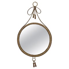 Miroir rond surréaliste avec bordure en métal torsadé et glands drapés