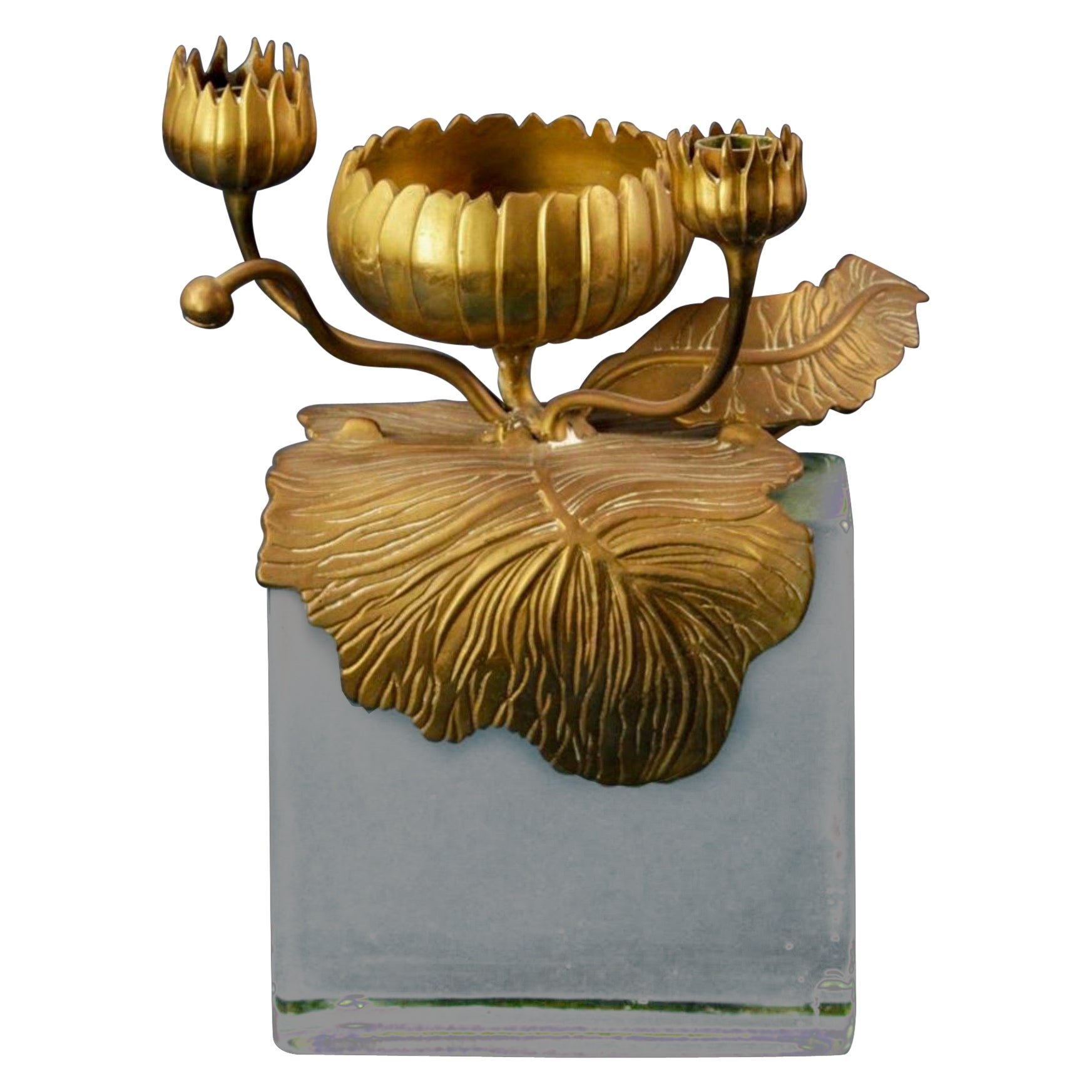 I love this! It is an unusual piece by Chapman. It is an art nouveau inspired lotus form bronze candle holder that wraps around a heavy glass block. It is marked and in very good condition. It dates to the later part of the 20th century. 