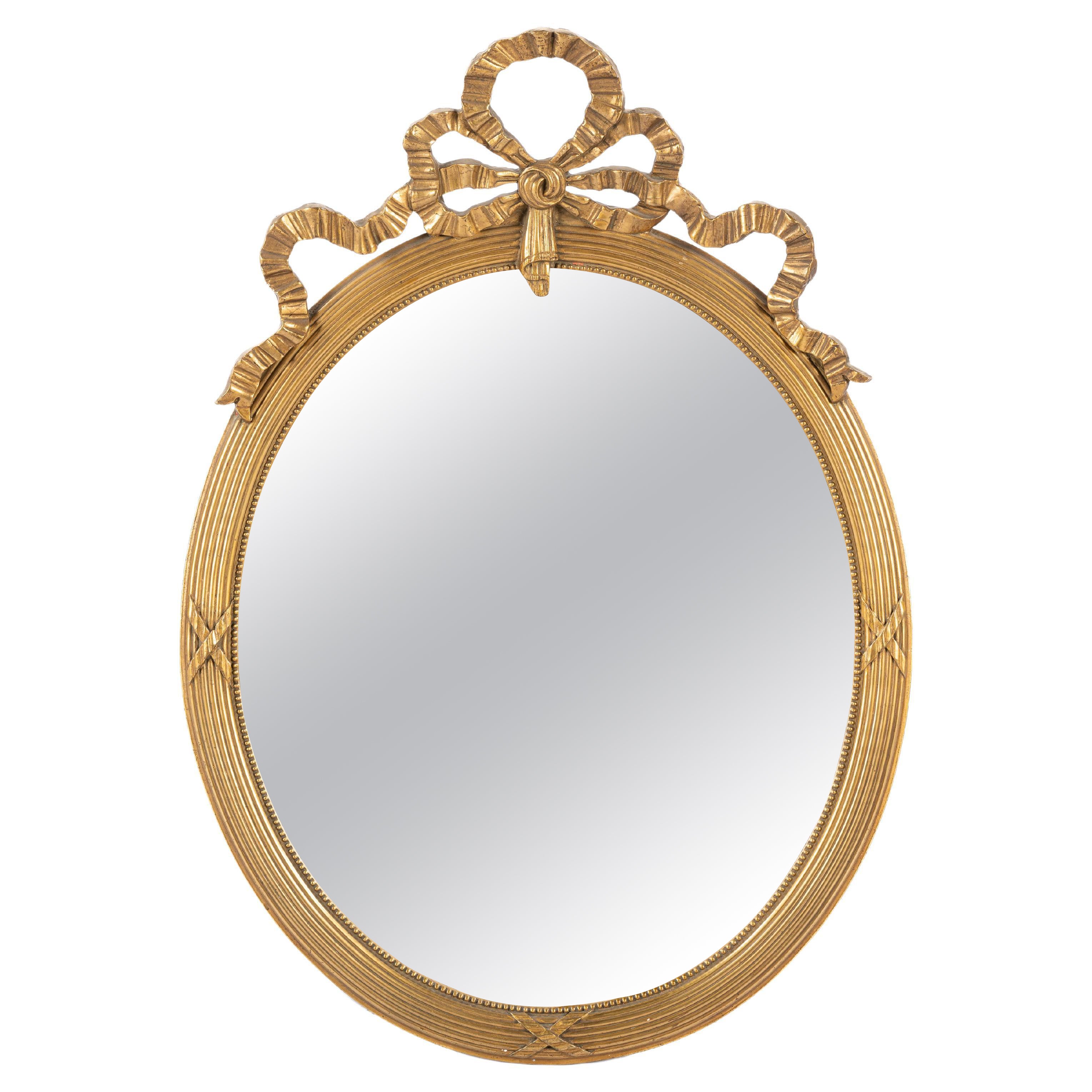 Antique early 20th-century French gold gilt Louis seize or Empire oval mirror  For Sale