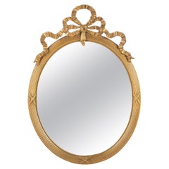 Antique miroir ovale Louis Seize ou Empire du début du 20e siècle, doré à l'or fin. 