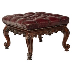 An early Victorian leather-upholstered rosewood stool