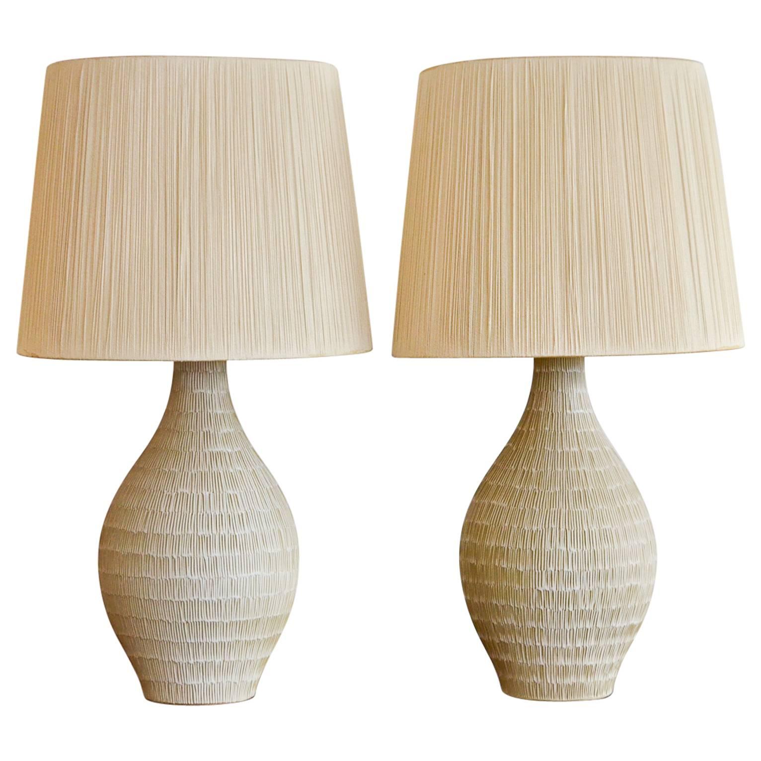 Pair of Incised Cream Ceramic Lamps with Original String Shades