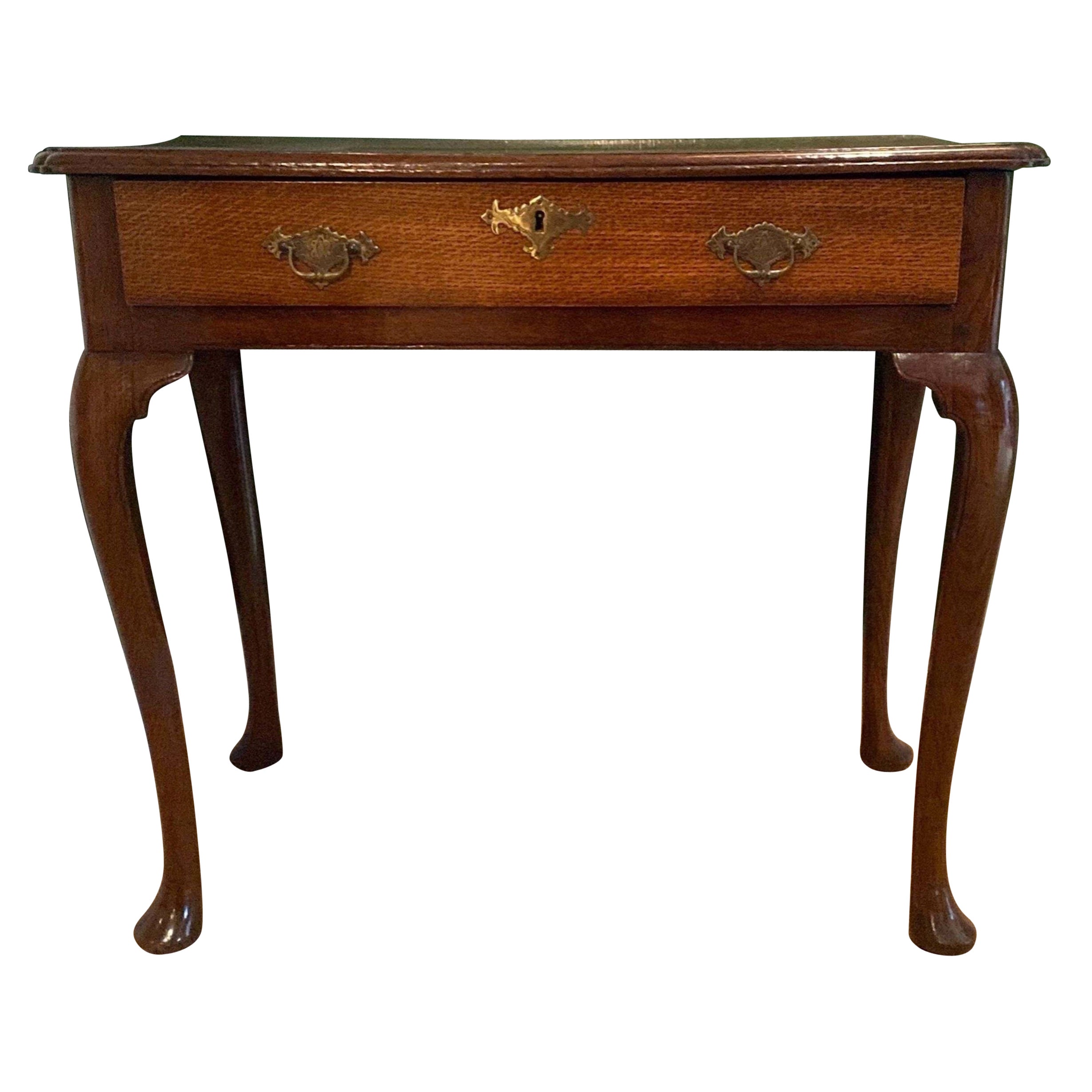 A George III side table in quarter sawn oak with a single drawer and pad feet. 
