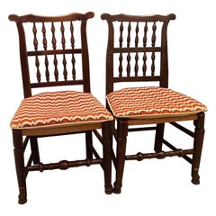 An assembled pair of George III Lancashire side chairs with ladder backs.