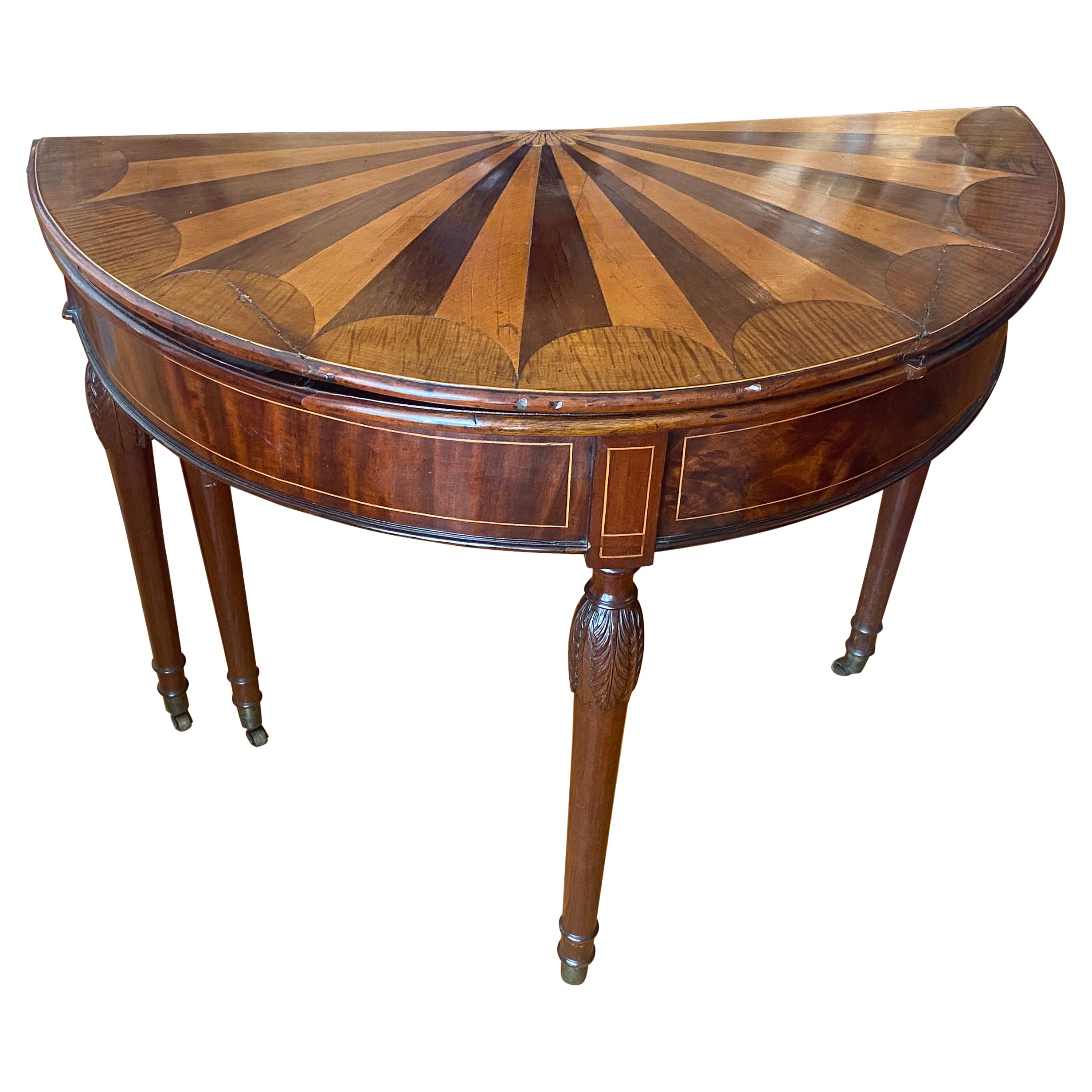 A George III fan shaped, specimen wood, inlaid demilune flip top card table.
